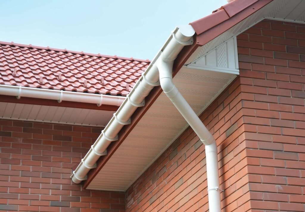White fascia, soffit and guttering along a tiled roof